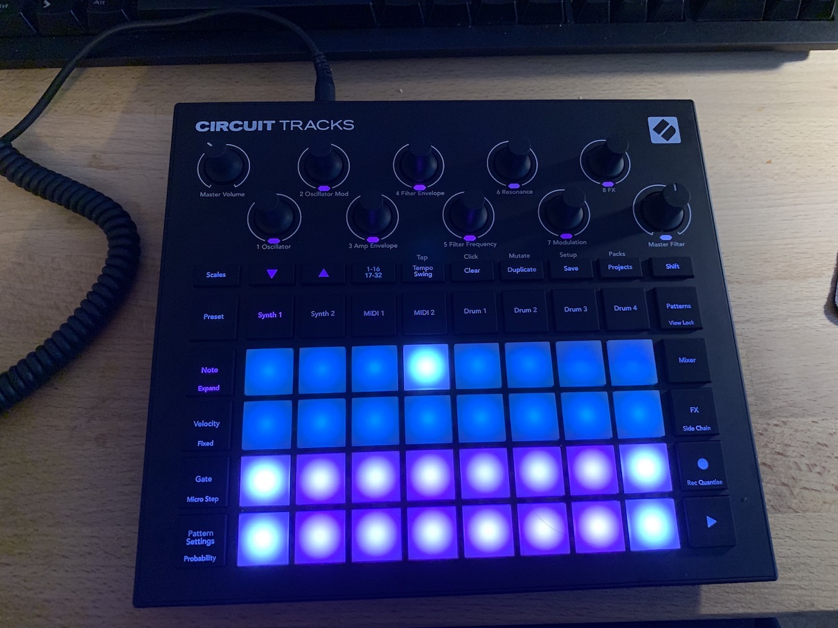 A Novation Circuit Tracks. An 8x4 grid of blue and purple lights with dials. It makes noise!